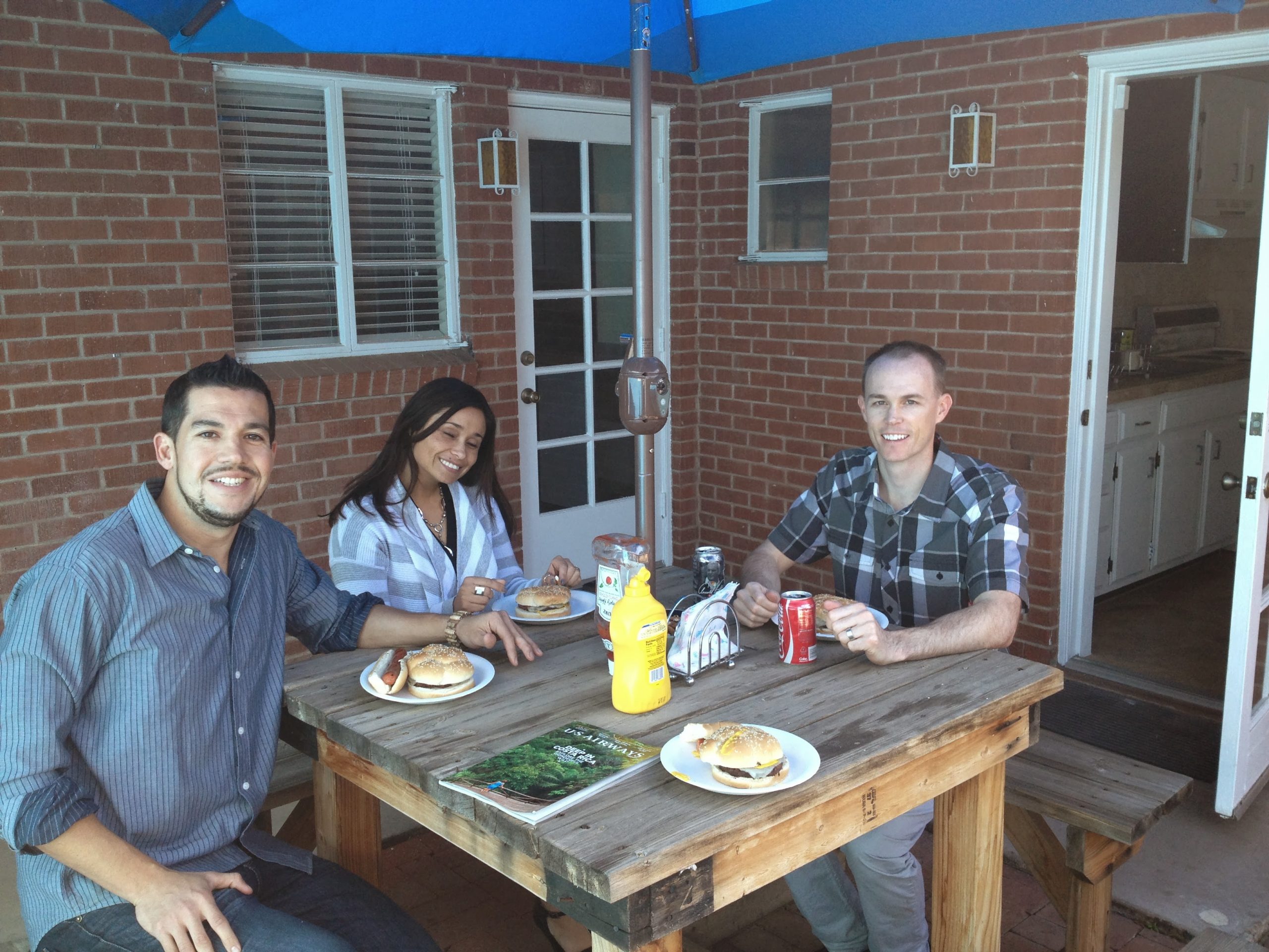 Natasha, Eric, and a fellow colleague sitting outside of the newly opened cross-cultural marketing agency office.